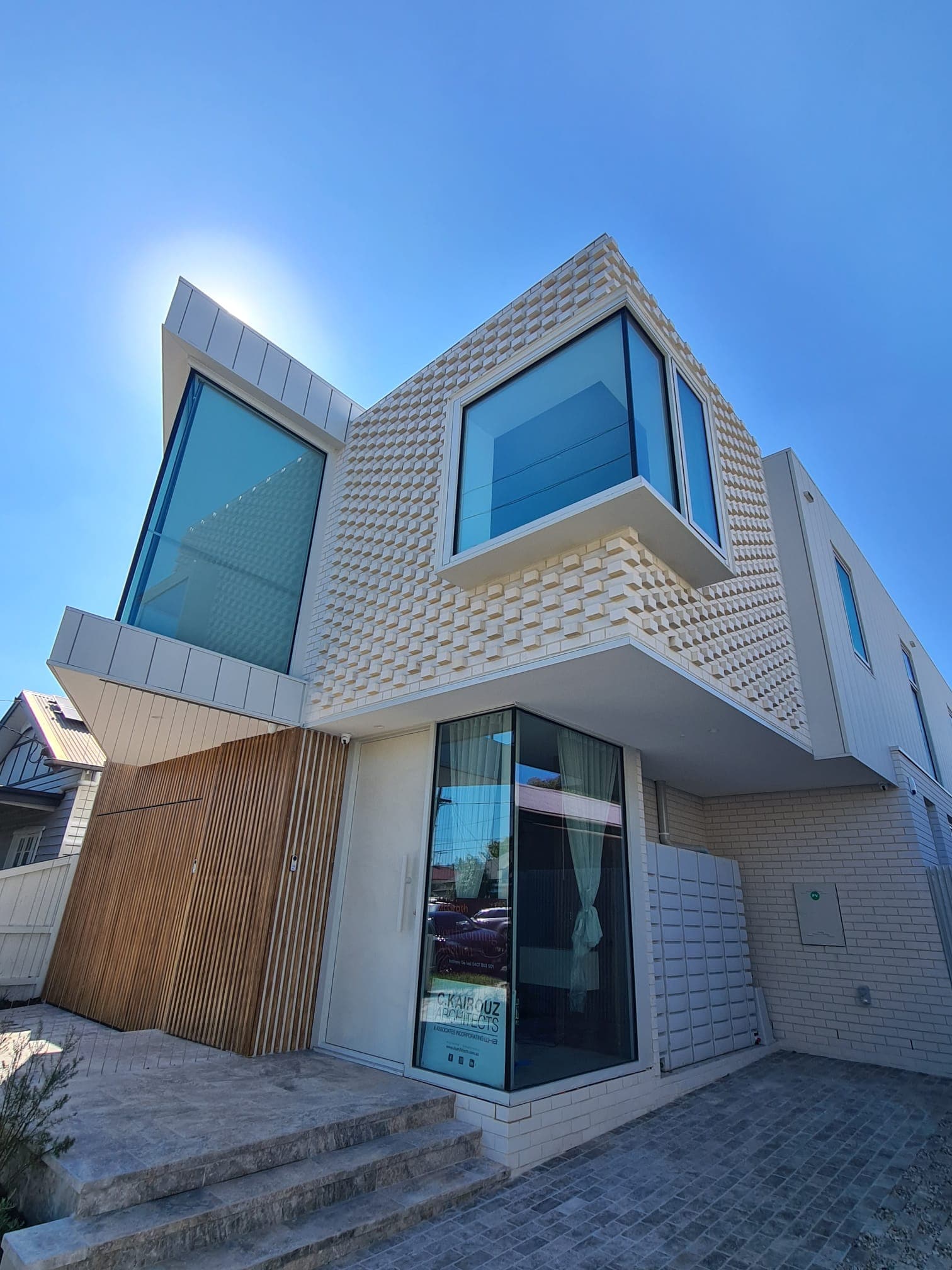 Two-storey contemporary home with a dental-pattern brick exterior by Goodwin Bricklaying