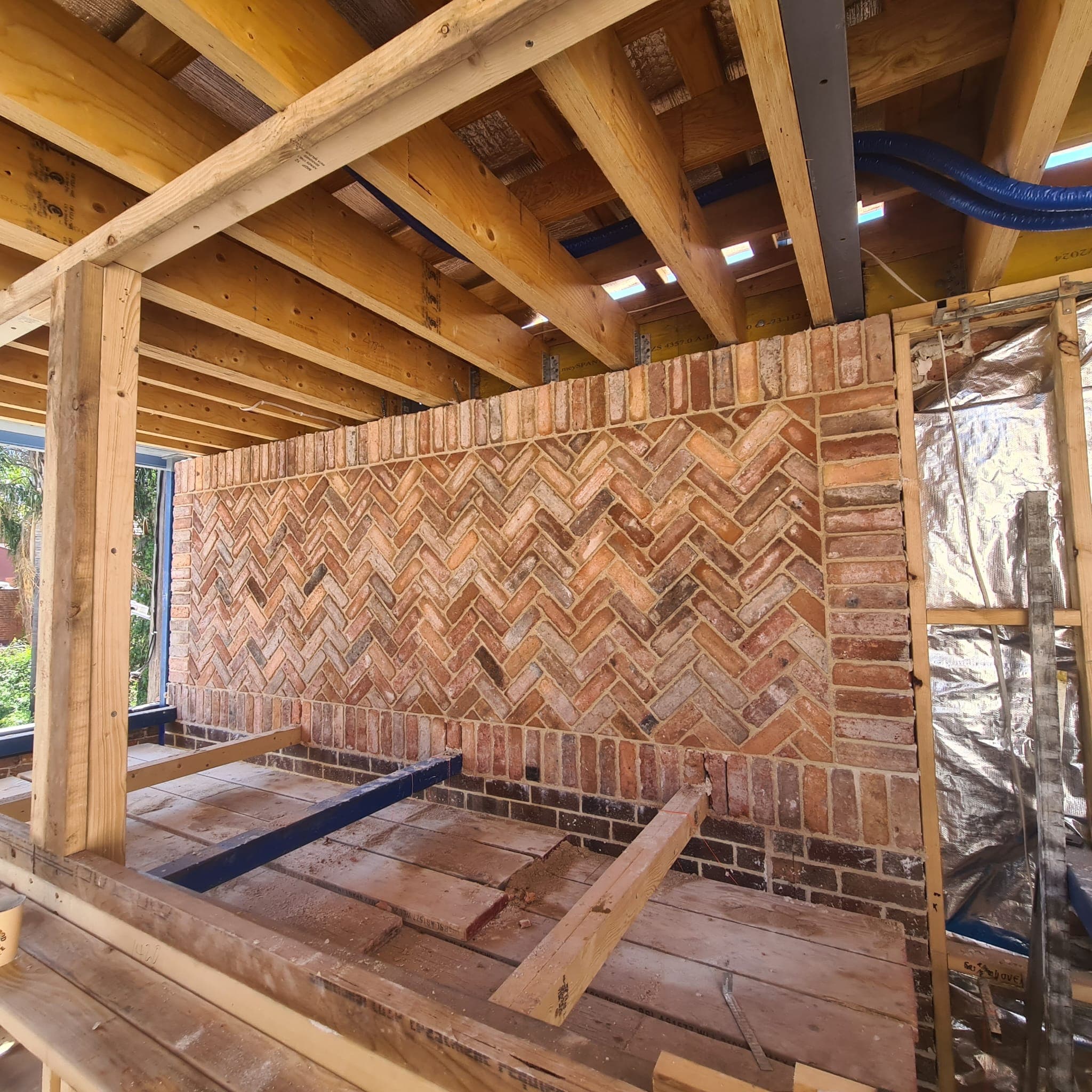 Completed interior herringbone brick feature wall handcrafted by Goodwin Bricklaying
