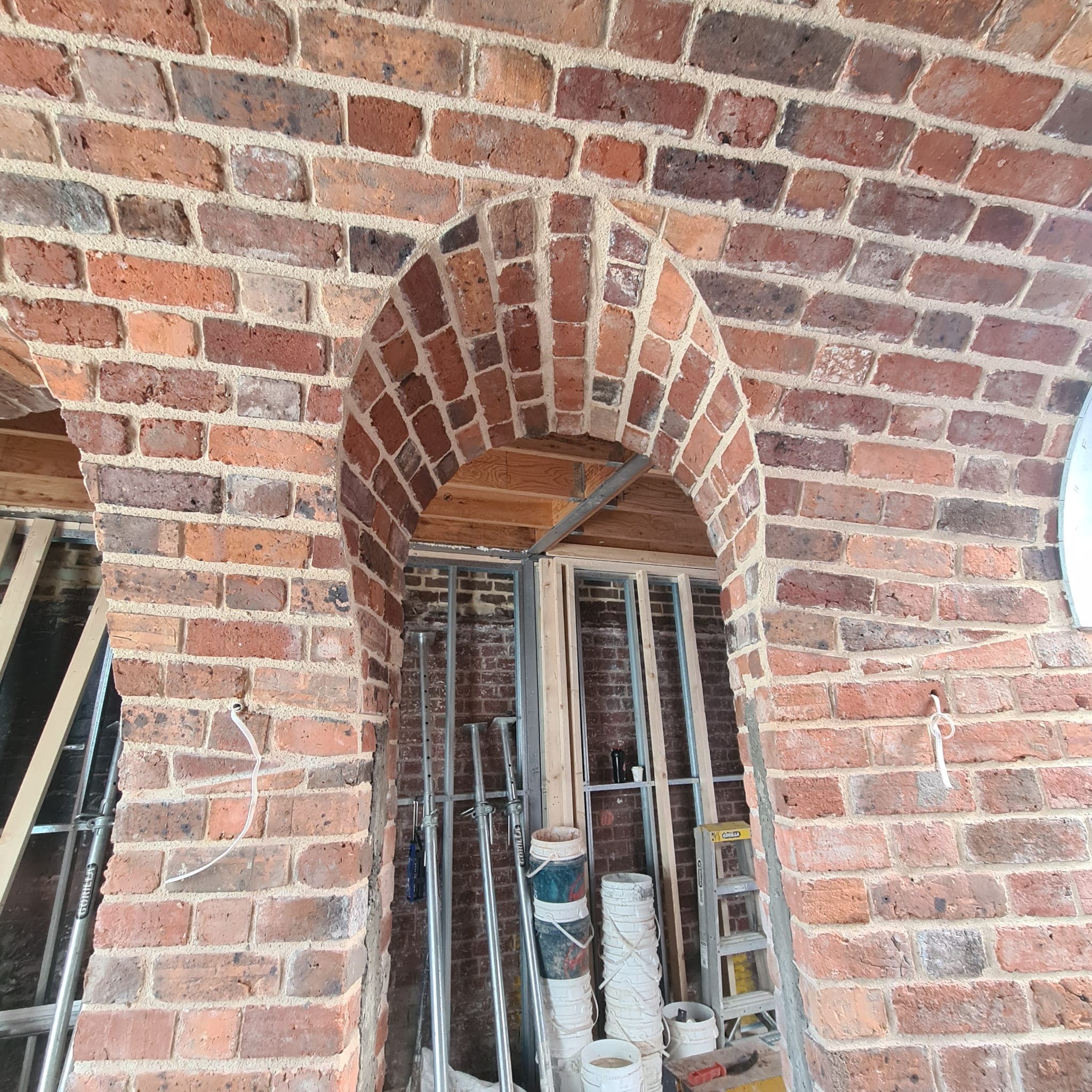 Hand-laid brick vault springing from the wall in a Fitzroy build by Goodwin Bricklaying