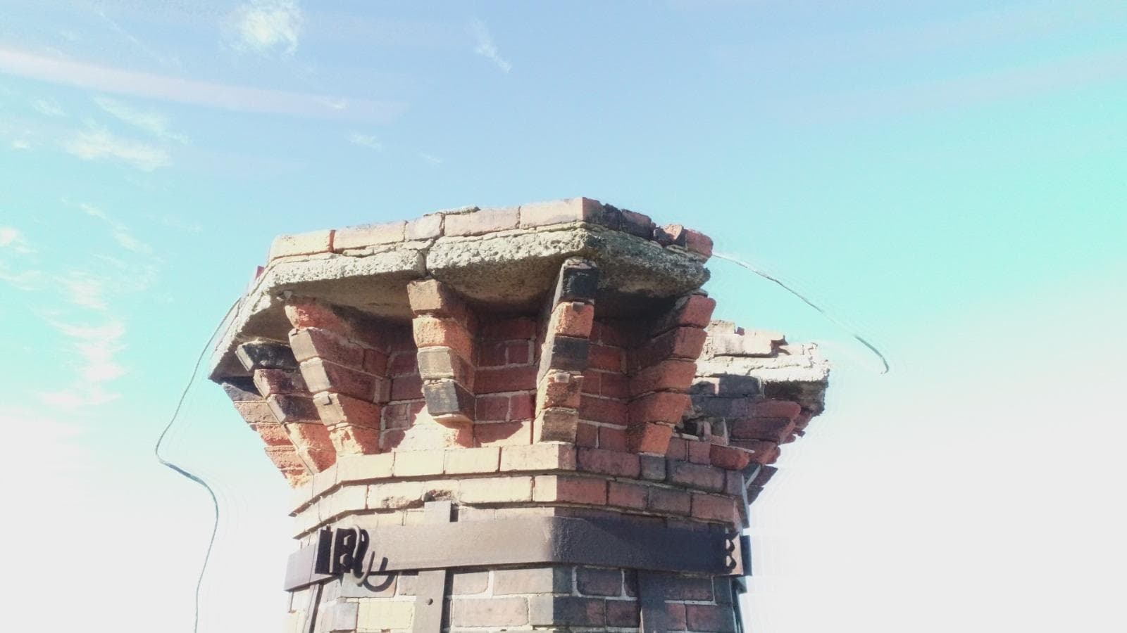 The original crown of the Old Licorice Factory chimney in Brunswick, cracked and losing brick before restoration