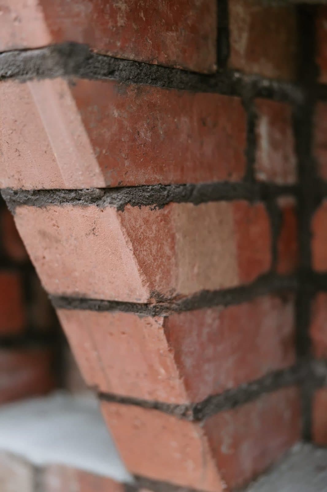 Close detail of the corbelled brick edge and mortar joints on the restored Old Licorice Factory chimney, Brunswick