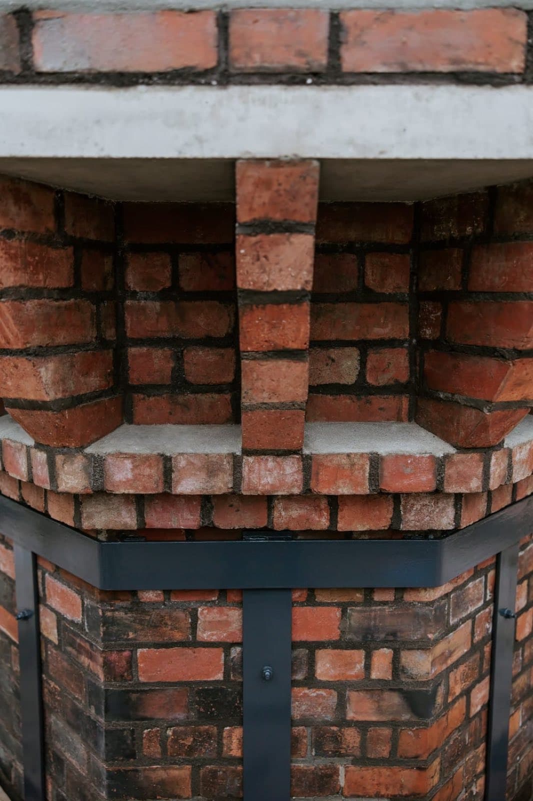 The central brick pier and corbelled courses of the rebuilt Old Licorice Factory chimney crown, Brunswick