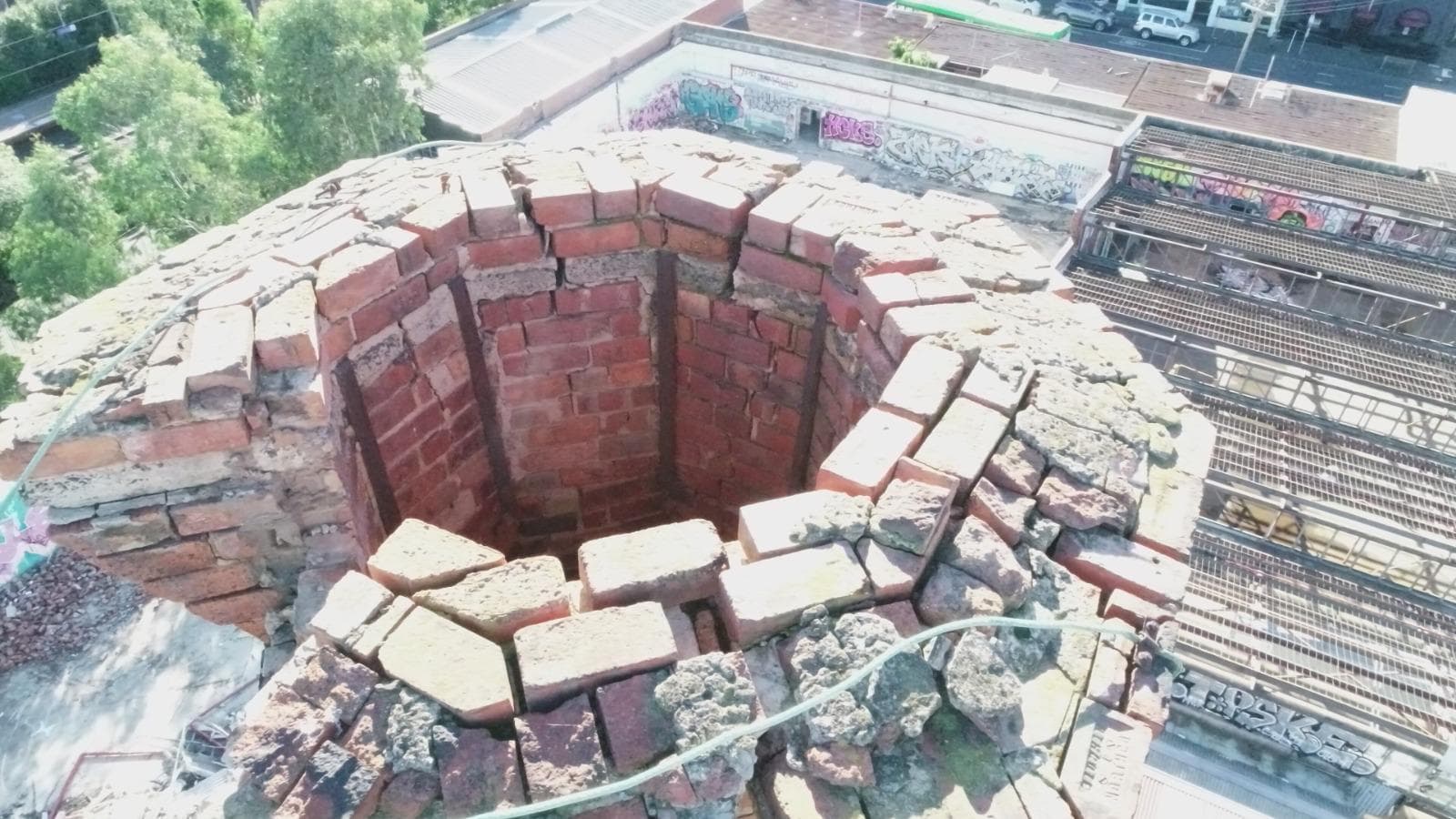 Aerial view down the flue of the Old Licorice Factory chimney in Brunswick, with the capping broken away before rebuild