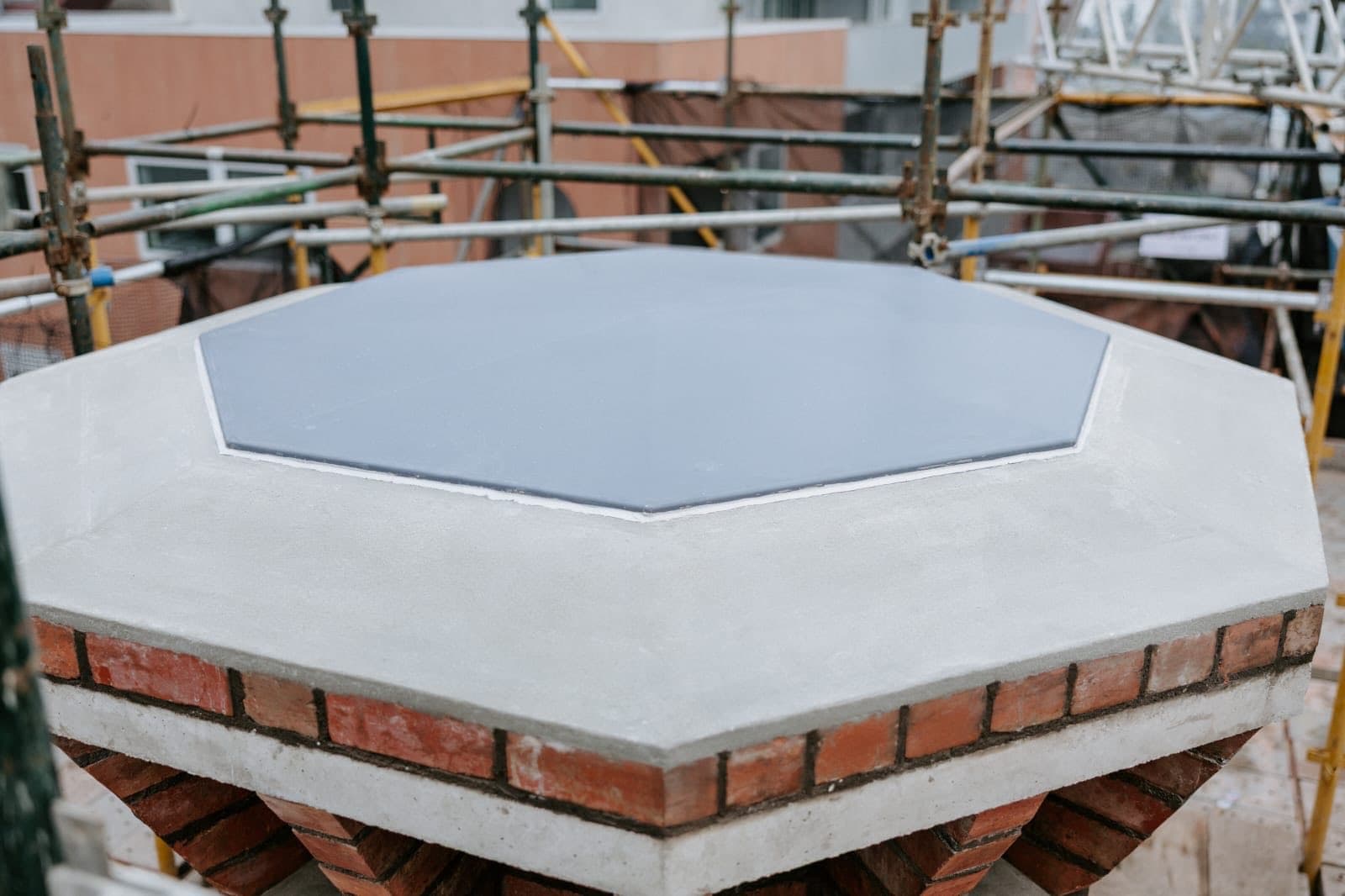 The new octagonal concrete capping slab set over the rebuilt Old Licorice Factory chimney crown, Brunswick