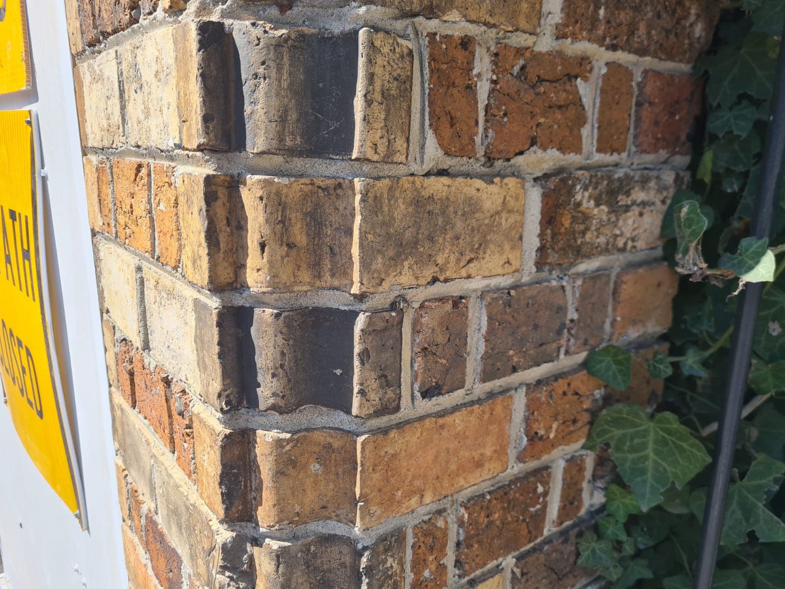 Close detail of the original handmade brick and weathered lime mortar on the Cairo flats heritage wall before restoration