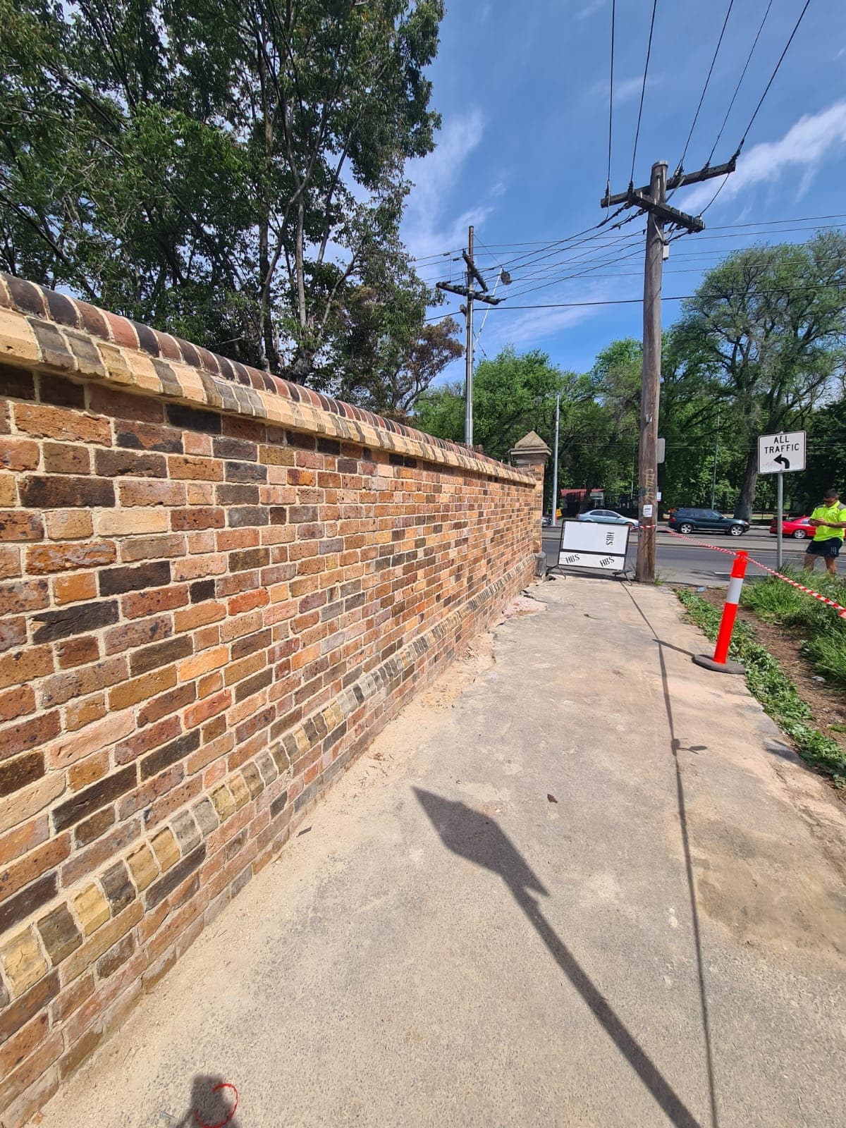 The restored Cairo flats heritage wall stretching the length of the boundary along the footpath, Fitzroy