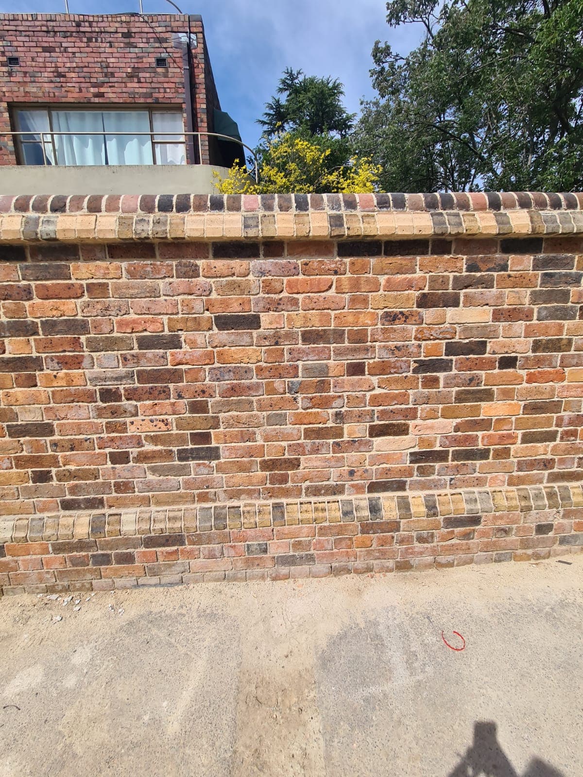 The finished elevation of the Cairo flats heritage wall, reclaimed brick relaid to the original bond and colour