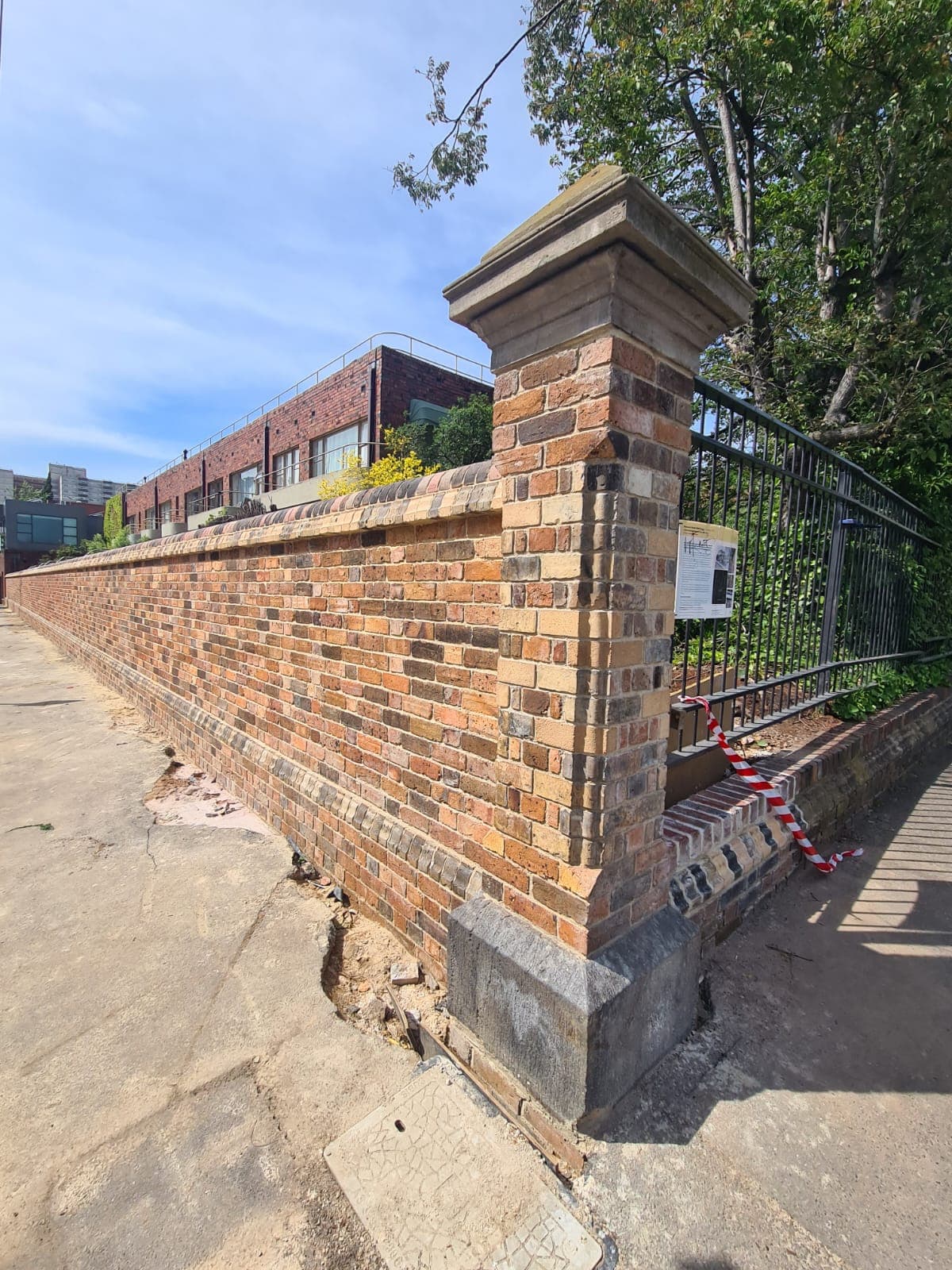 Heritage red-brick boundary wall rebuilt brick by brick with a sandstone-capped pier by Goodwin Bricklaying, Fitzroy