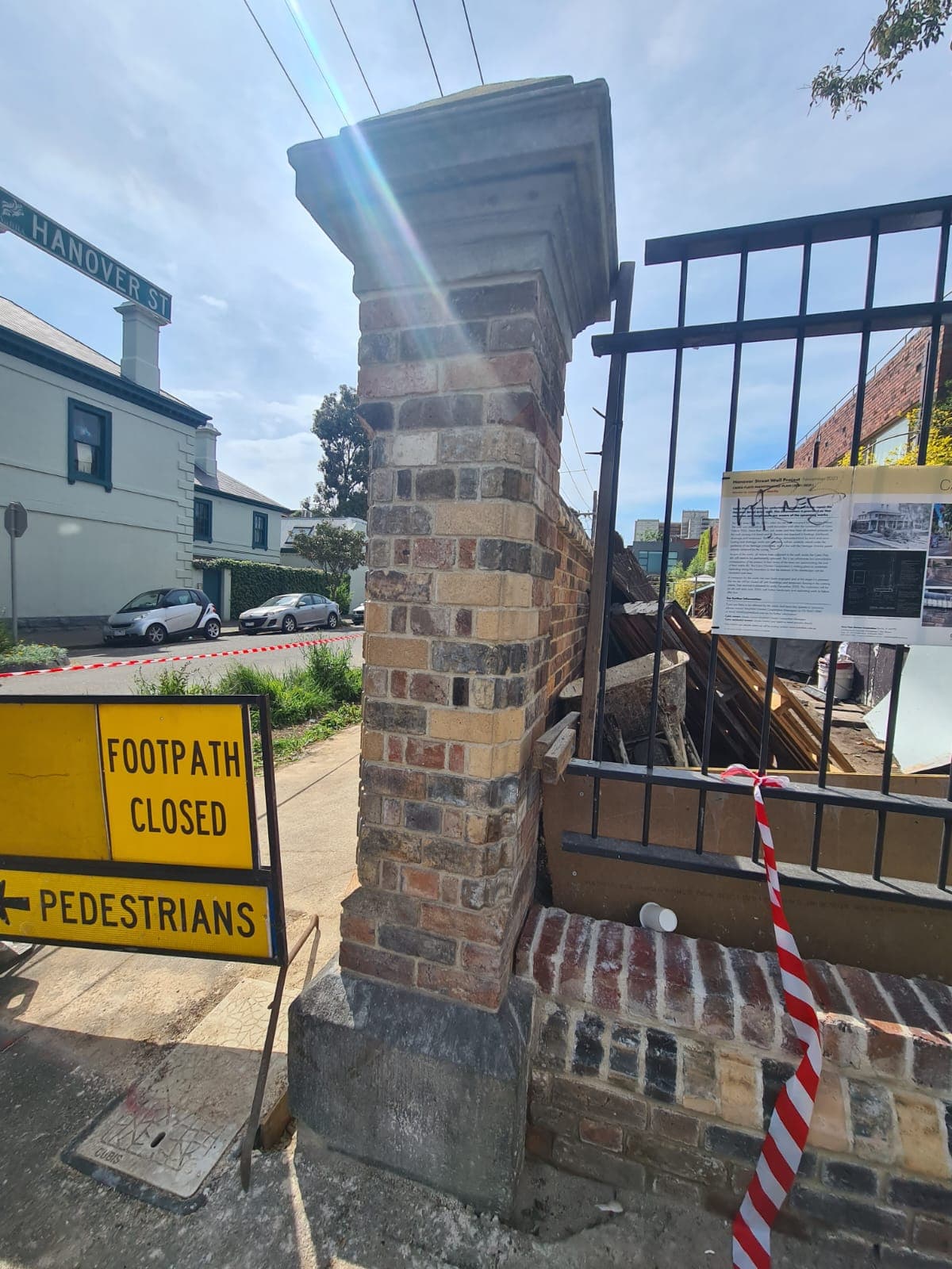 The rebuilt pier on the corner of Hanover Street, Fitzroy, beside the heritage interpretation board during the works