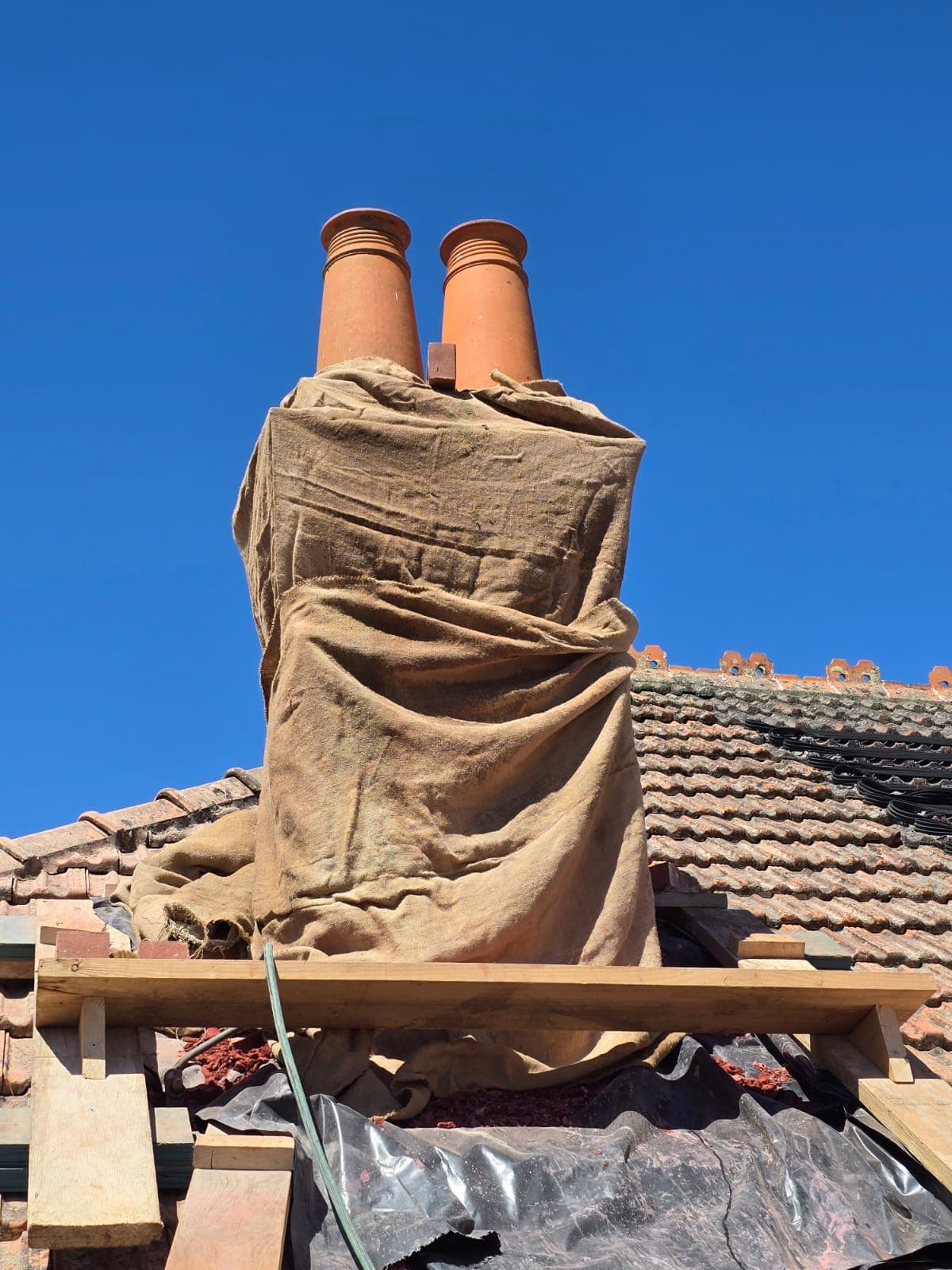 Heritage chimney stack restoration on a Canterbury tiled roof by Goodwin Bricklaying