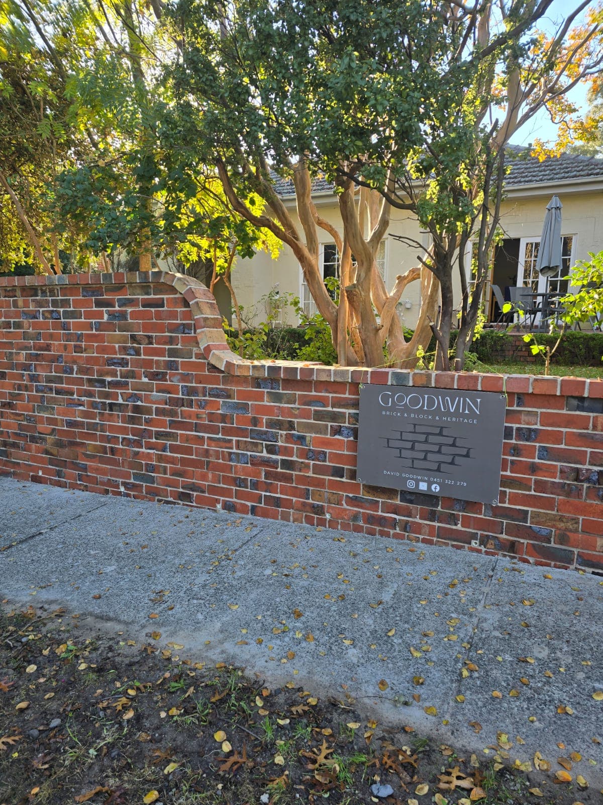 Completed heritage red-brick front garden wall with the Goodwin Bricklaying sign, Melbourne