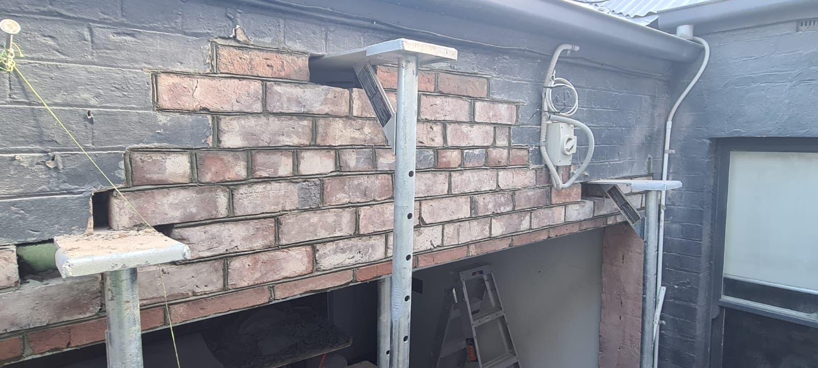 Reclaimed brickwork rebuilt over a new opening in a heritage wall by Goodwin Bricklaying, Melbourne