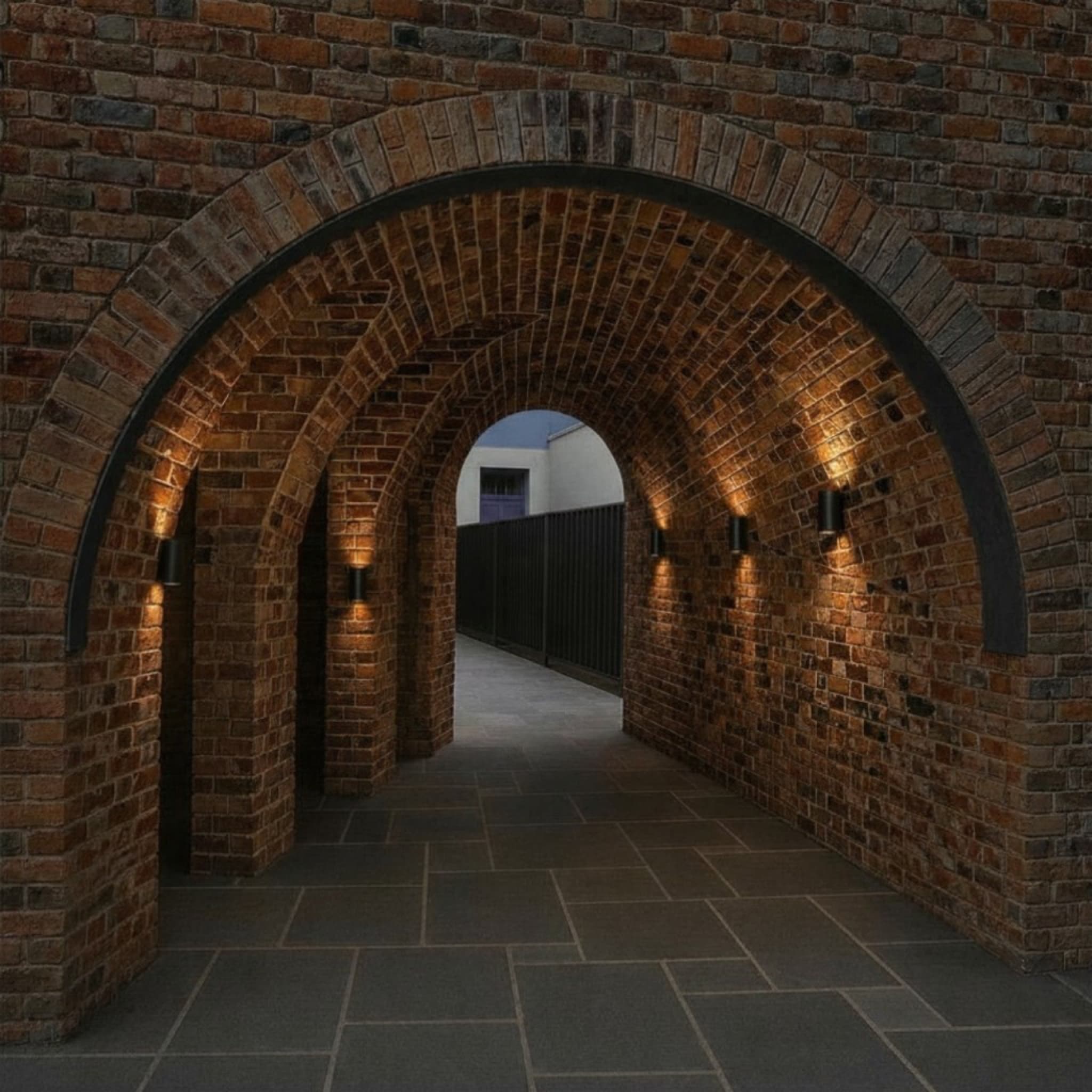 Warmly lit heritage brick archway and vaulted tunnel handcrafted by Goodwin Bricklaying in Melbourne