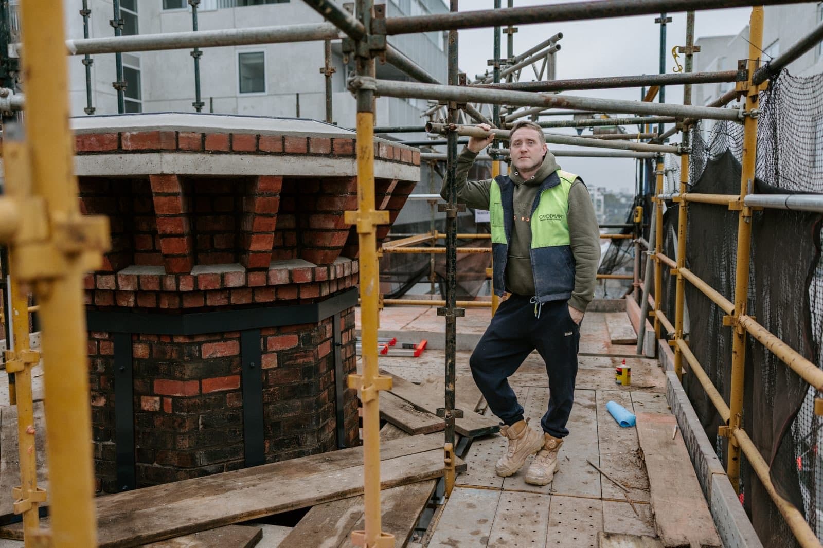 David Goodwin on the scaffold deck beside the rebuilt Old Licorice Factory chimney crown in Brunswick