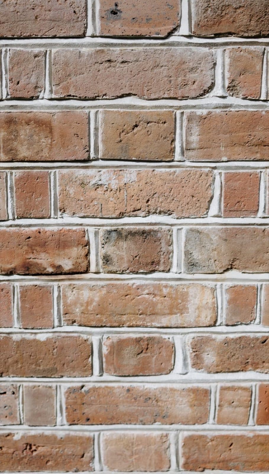 Close detail of a bird's beak mortar joint struck to a fine central ridge on pale brickwork by Goodwin Bricklaying