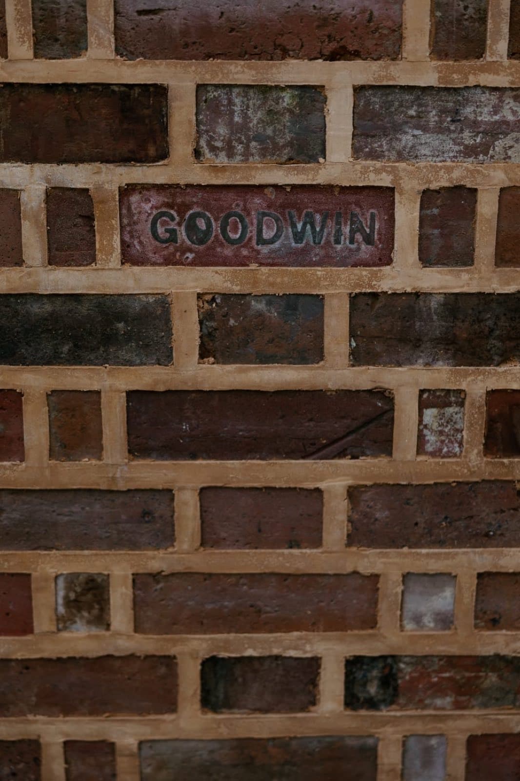 Close detail of ribbon pointing, a raised flat band of pale mortar standing proud of dark heritage brickwork, by Goodwin Bricklaying